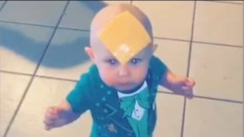 Baby petrified of cheese slice on forehead