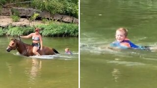 Horse pulls kid through water by his tail