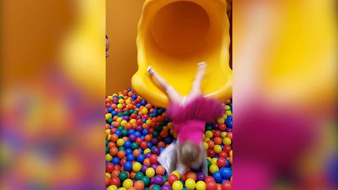 Tot Girl Slides Into A Ball Pit Headfirst