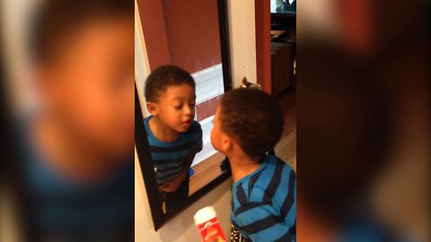 Boy Adorably Confused By Reflection In Mirror