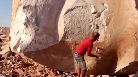 Man manages to split this massive stone with ease