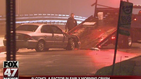 Driver crashes, knocks down light pole in Lansing