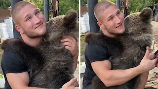 Caretaker receives the most emotional hug from baby bear