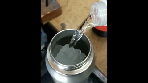 The water freezing as soon as it touches the container