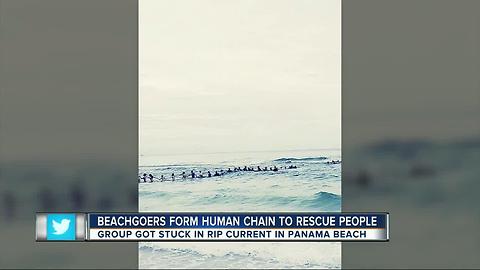 Beachgoers form human chain to rescue family in water