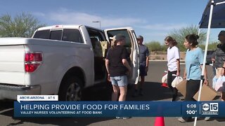 Healthcare workers donate food to needy families