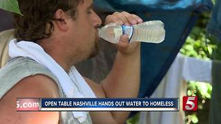 Outreach Workers Give Water To Homeless
