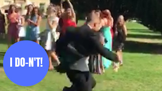 Hilarious footage shows man doing a runner after his girlfriend catches bride's bouquet