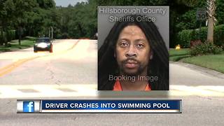 Driver crashes into swimming pool