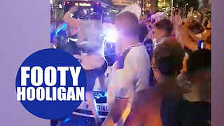 Football hooligan jumps on top of police car during England World Cup celebrations