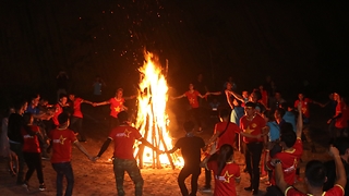 Wonderful dancing around big fire in the forest