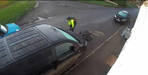 Cyclist slips on rainy road and crashes into a van