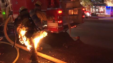 A firefighter catches fire while battling a structure fire in Sherman Oaks, California.
