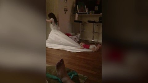 Just A Cute Little Girl Wearing Her Mom’s Wedding Dress