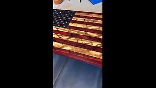 Wooden American flag with firearm background.