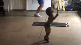 Toddler joins dad in jump rope workout