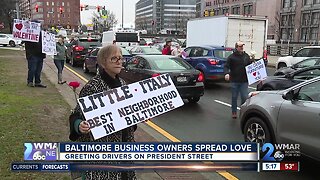 Baltimore business owners spread love by greeting drivers on President Street