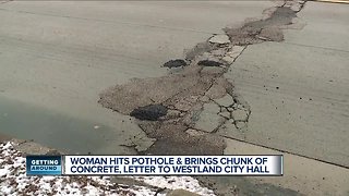 Frustrated driver brings chunk of concrete to Westland city hall