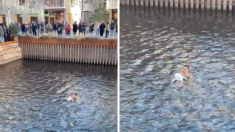 Woman jumps into water to save bird stuck in plastic bag