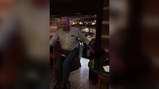 A Tipsy Senior Man Falls While Trying To Ride A Unicycle