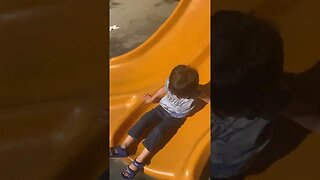 Baby boy loves the slide -beautiful day at park