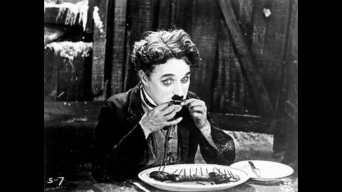 Charlie Chaplin eats his shoe for Thanksgiving
