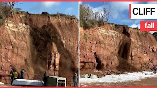 Large section of cliff collapses onto popular beach