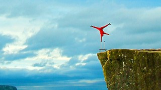 Balancing Artist Performs One-Armed Handstand Stunt Over 2,000 Feet Drop