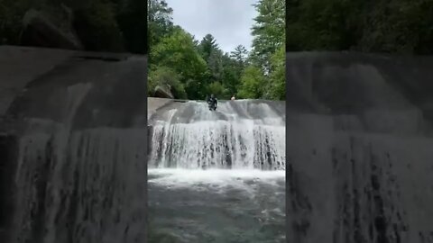 Sliding down Turtleback Falls in North Carolina