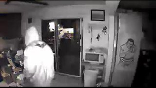 Two burglary suspects caught on surveillance video take items from retired police officer's home