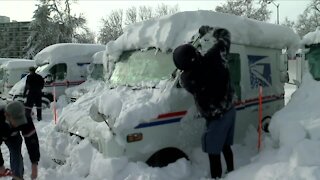 Postal workers brave conditions to deliver mail