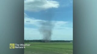 Dust devil sweeps through a farmer's field