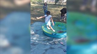 Young Girl Slips As She Attempts To Jump Into A Kiddie Pool