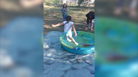 Young Girl Slips As She Attempts To Jump Into A Kiddie Pool