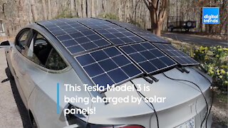 This Tesla Model 3 is being charged by solar panels