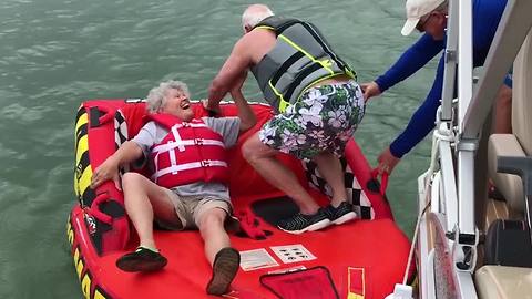 An Old Couple Tries To Get On Inflatable Tube