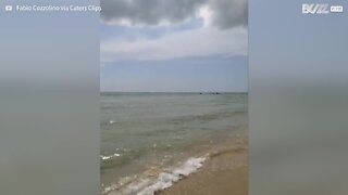 Sand swirl scatters beachgoers in Italy