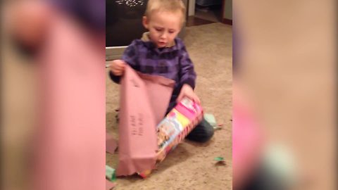 "A Tot Boy Opens A Christmas Present And Finds A Barbie Doll"