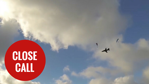 Royal Navy Hawk narrowly misses paragliders