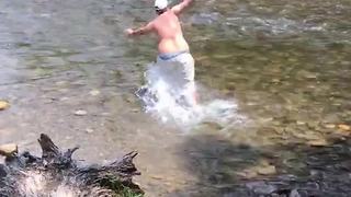 A Guy In A River Gets Knocked Over By Current