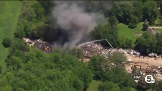 Fire crews work to contain large fire at salvage yard in Carlisle Township