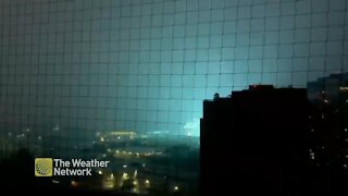 Transformer struck by lightning strike emits brilliant flash of electricity
