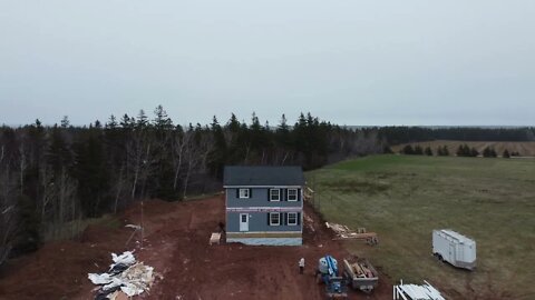 Dronie shot of a house being built