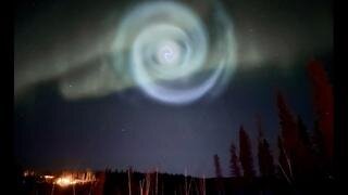 A spiraling aurora appears in Alaskan skies