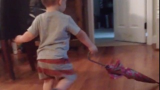 Don't own a push broom? Use an umbrella! : Toddler shows hard work ethic by sweeping floor with umbrella