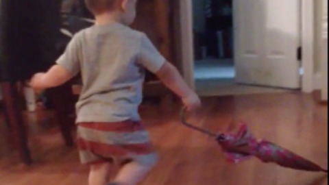 Don't own a push broom? Use an umbrella! : Toddler shows hard work ethic by sweeping floor with umbrella