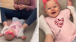 Mom Uses Funny Technique To Dress Her Baby