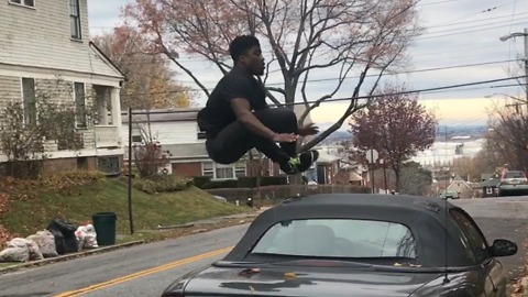 A Guy Flips and Jumps Over Cars Saying "It's Easy"