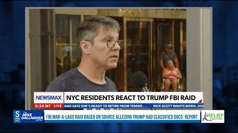 A man is standing in front of Trump Tower with an "Arrest Trump" sign. When asked what Trump should be charged with, he is at a loss for words.