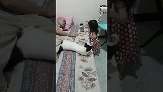 Baby cutie girl plays with her grandfather and talks with the cat